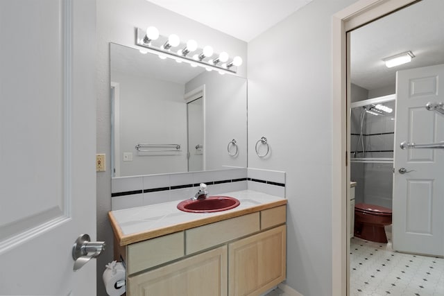 bathroom featuring toilet, a shower with shower door, and vanity