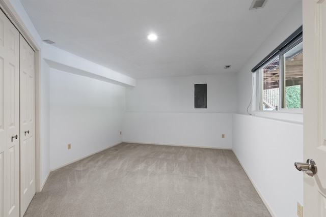 unfurnished room with light carpet and electric panel