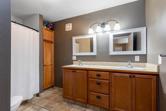 bathroom featuring vanity, a shower with shower curtain, and toilet