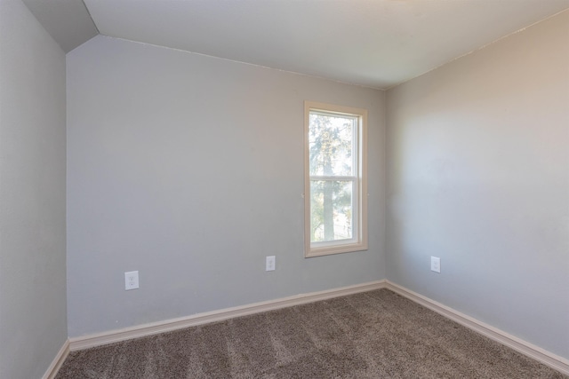 unfurnished room with lofted ceiling and carpet floors