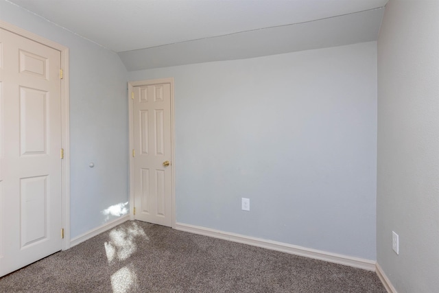 unfurnished room featuring vaulted ceiling