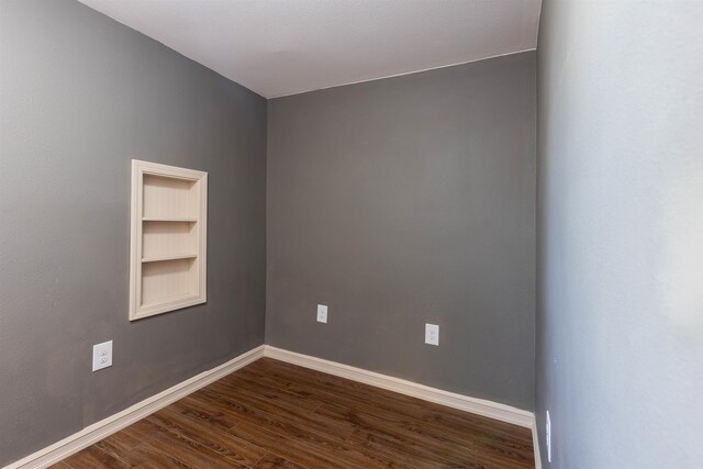 spare room featuring dark hardwood / wood-style flooring