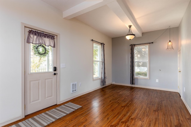 foyer featuring beam ceiling and dark hardwood / wood-style floors