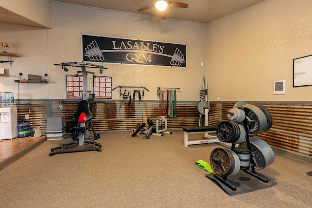 exercise area featuring carpet floors and ceiling fan