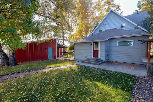 back of property with a patio and a lawn