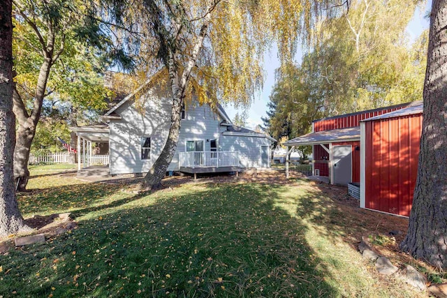 view of yard with a storage shed and a deck