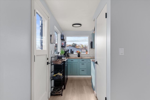 corridor with light hardwood / wood-style floors