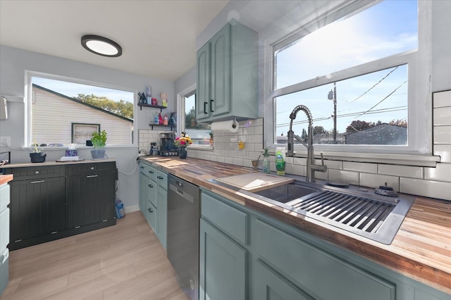 kitchen featuring sink, light hardwood / wood-style flooring, wooden counters, stainless steel dishwasher, and backsplash