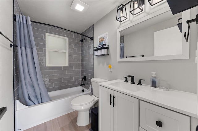 full bathroom featuring vanity, hardwood / wood-style floors, shower / bathtub combination with curtain, and toilet