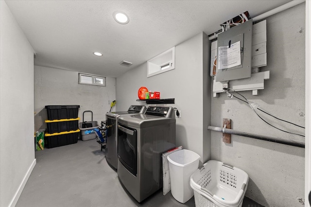 laundry room featuring baseboards, visible vents, recessed lighting, a textured ceiling, and washer and clothes dryer