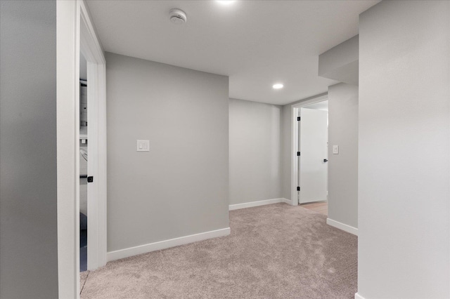 hallway with light colored carpet