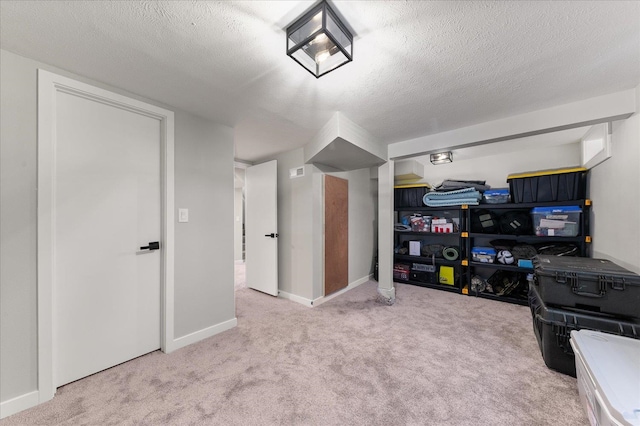 rec room featuring baseboards, a textured ceiling, and carpet