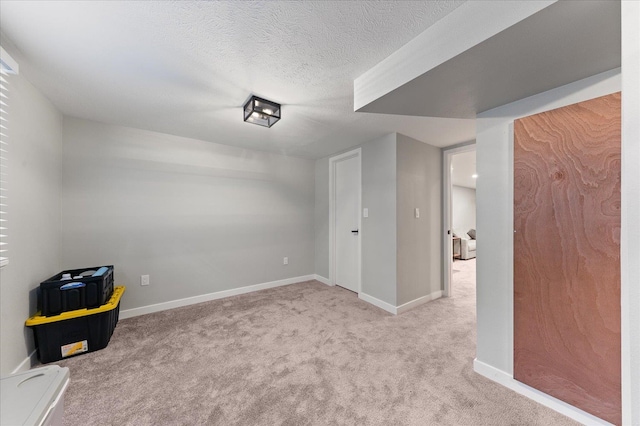 unfurnished room featuring light colored carpet and a textured ceiling