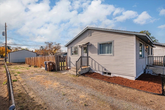 bungalow-style home featuring fence