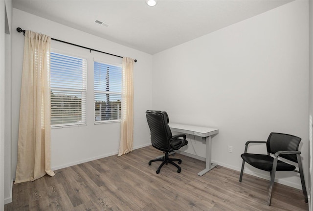 home office with wood-type flooring