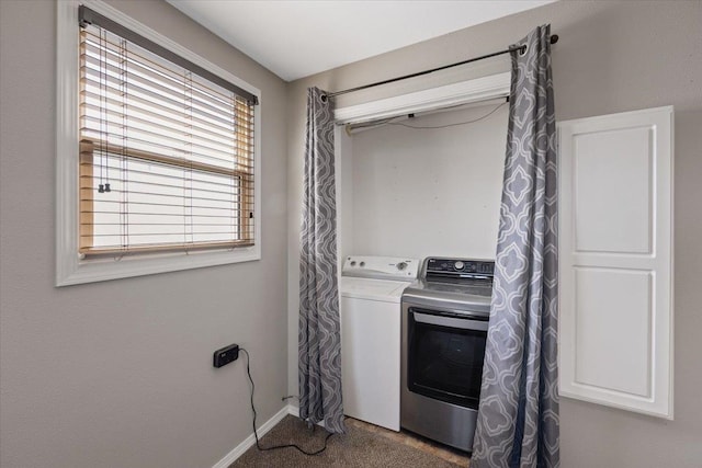 laundry room featuring dark carpet and separate washer and dryer