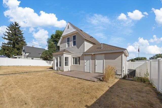 rear view of property with a yard and cooling unit