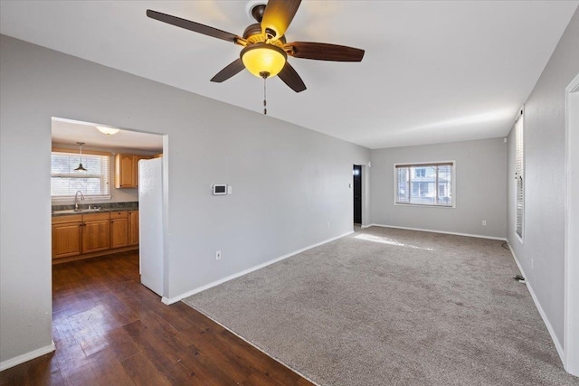 spare room featuring sink, ceiling fan, and dark hardwood / wood-style flooring