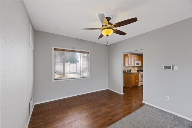 unfurnished room featuring dark hardwood / wood-style floors and ceiling fan