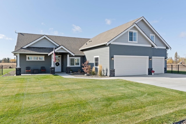 craftsman house with a garage and a front lawn