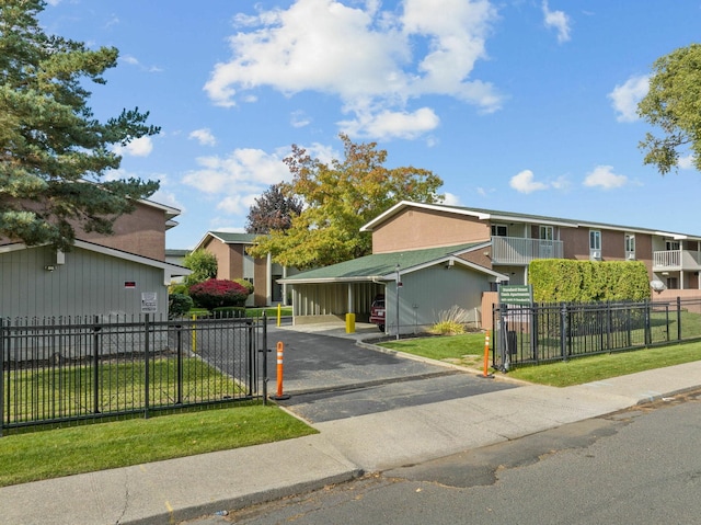 view of front of house featuring a front yard and a balcony