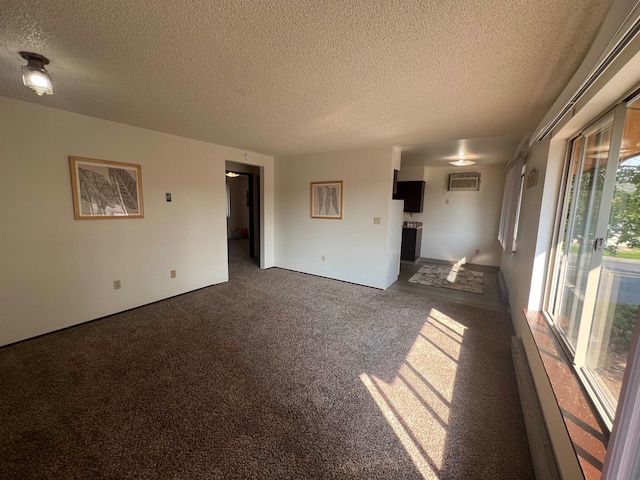 unfurnished living room with dark carpet, a wall mounted AC, and a textured ceiling