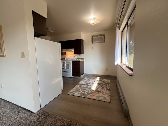 kitchen featuring an AC wall unit, dark wood-type flooring, white appliances, and baseboard heating