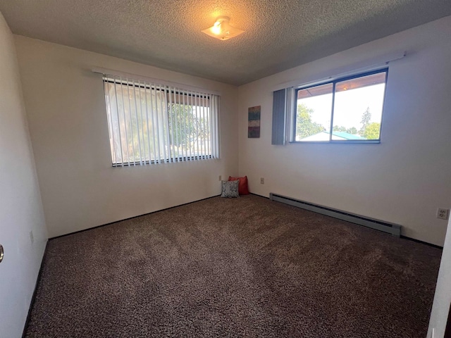 unfurnished room with a textured ceiling, a baseboard heating unit, and carpet floors