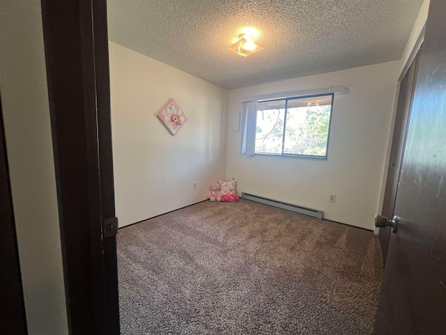 unfurnished room featuring a textured ceiling, carpet flooring, and a baseboard radiator