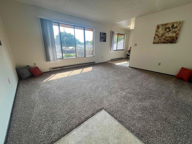 carpeted spare room featuring baseboard heating and a textured ceiling