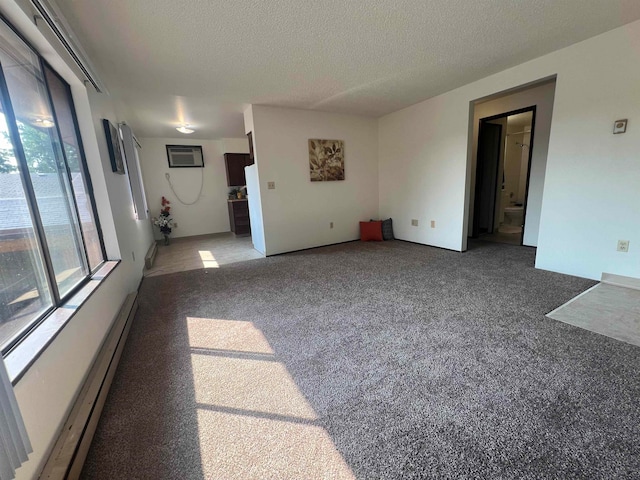 unfurnished living room with carpet, a textured ceiling, baseboard heating, and a wall unit AC