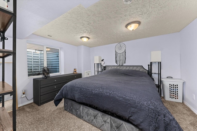 carpeted bedroom with a textured ceiling