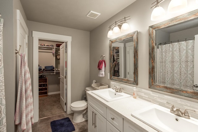 bathroom featuring tile patterned floors, decorative backsplash, toilet, curtained shower, and vanity