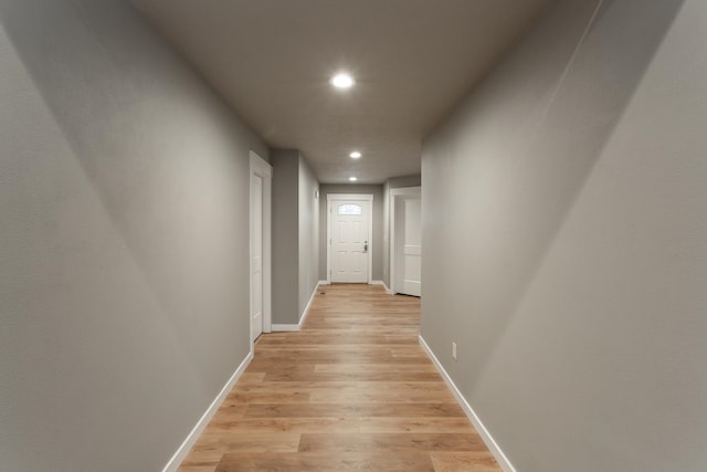 corridor with light hardwood / wood-style floors