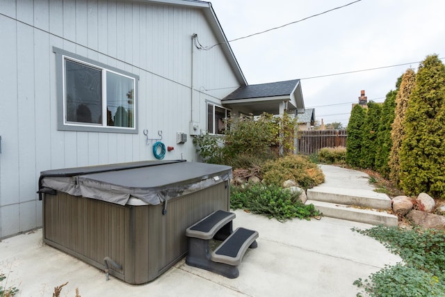 exterior space with a hot tub and a patio area