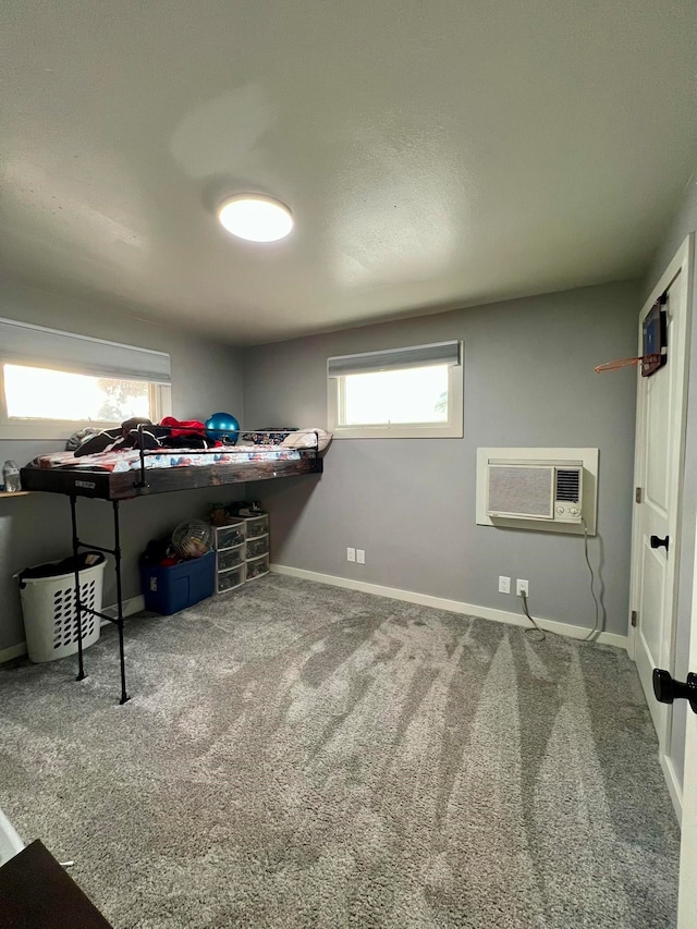 carpeted bedroom with a wall mounted AC