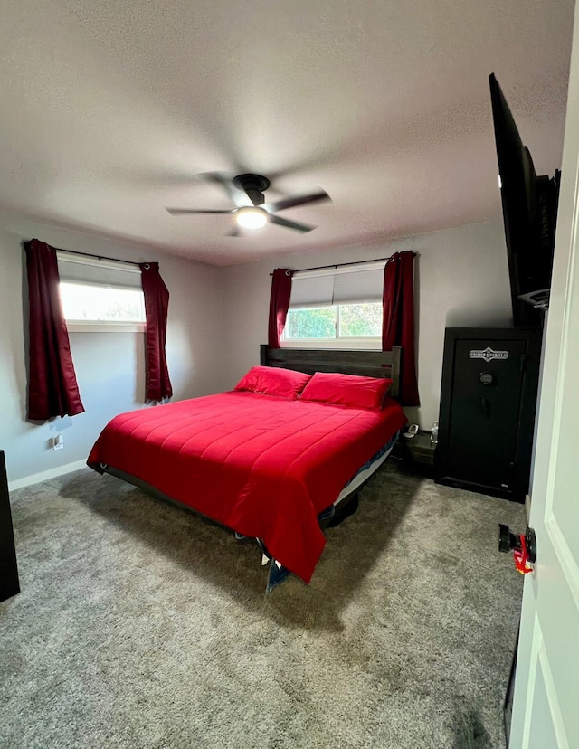 carpeted bedroom with ceiling fan, a textured ceiling, and multiple windows