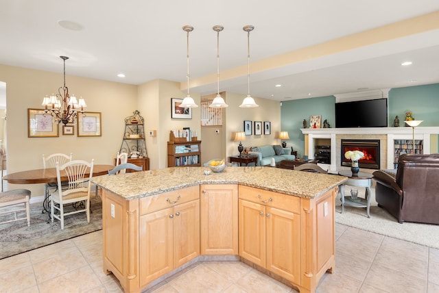 kitchen with a notable chandelier, light brown cabinetry, a center island, and pendant lighting