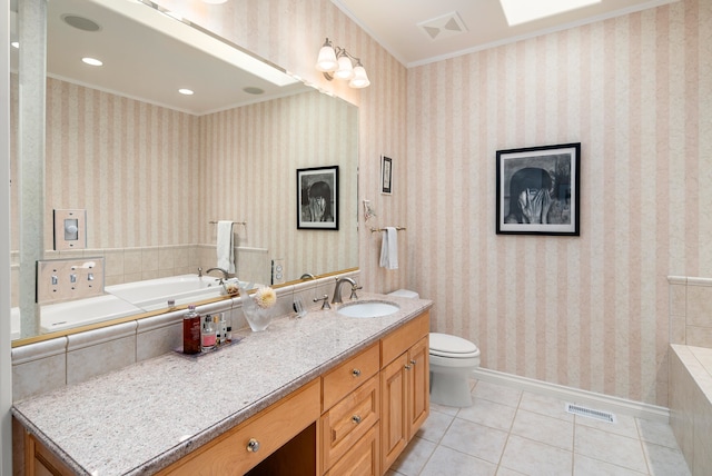 bathroom with a tub, toilet, ornamental molding, vanity, and tile patterned flooring