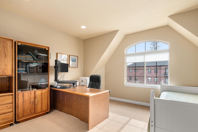 carpeted office featuring vaulted ceiling