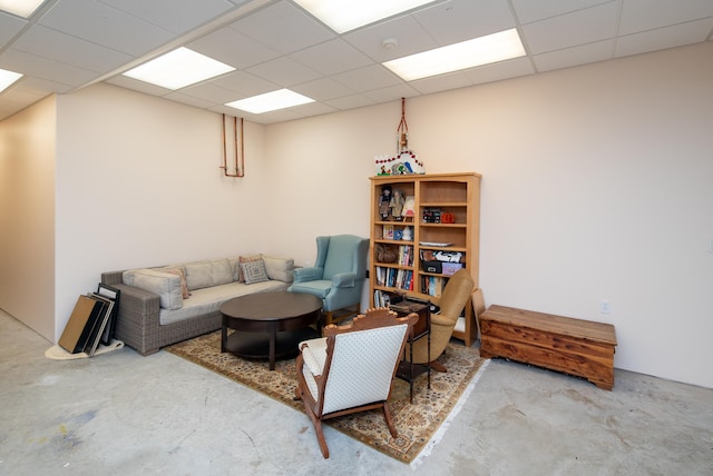 living room with a drop ceiling