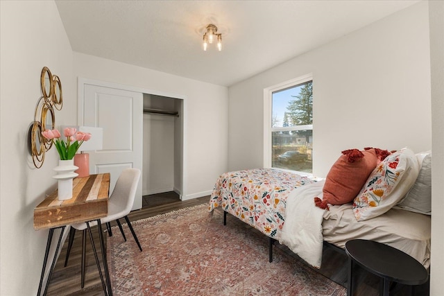 bedroom with a closet and dark hardwood / wood-style flooring