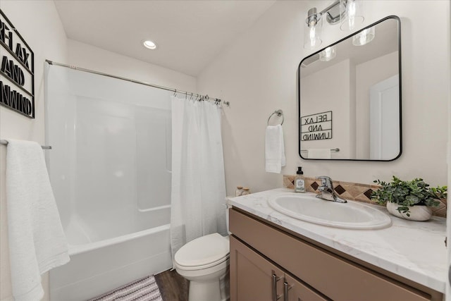 full bathroom with toilet, shower / tub combo with curtain, vanity, and wood-type flooring