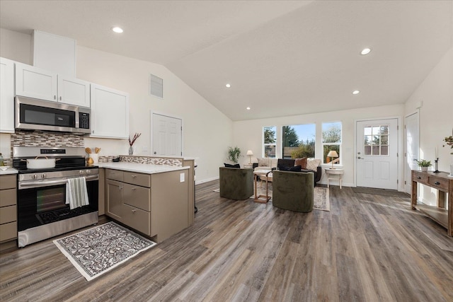 kitchen featuring gray cabinetry, white cabinetry, stainless steel appliances, lofted ceiling, and hardwood / wood-style flooring