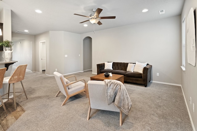 living room featuring light carpet and ceiling fan