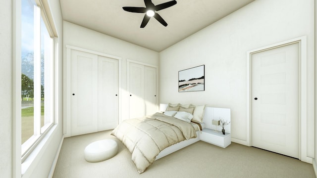 bedroom with two closets, light colored carpet, and ceiling fan