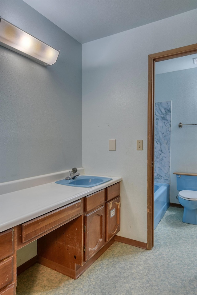 3224 E 28th Ave, Spokane, WA 99223 - bathroom featuring toilet, baseboards, and vanity