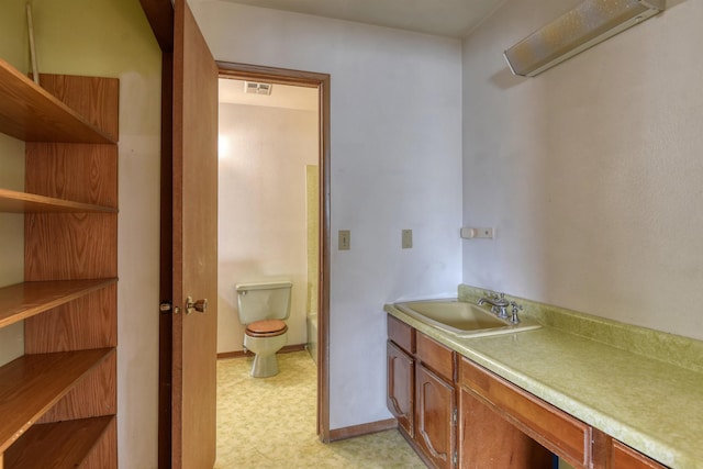 3224 E 28th Ave, Spokane, WA 99223 - bathroom with toilet, vanity, visible vents, tile patterned floors, and baseboards