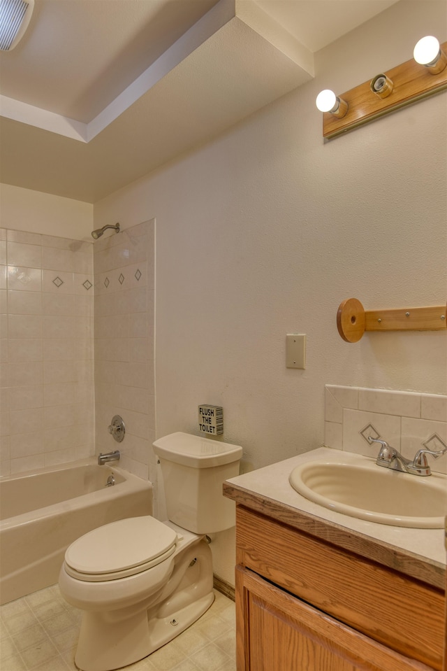 full bathroom with vanity, toilet, and tiled shower / bath combo