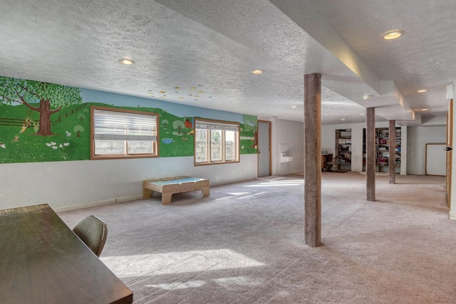 rec room with light carpet and a textured ceiling